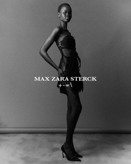 Fashion photo of a single adult female with dark skin, wearing a short black dress and high heels, in a photo studio with a grey background.