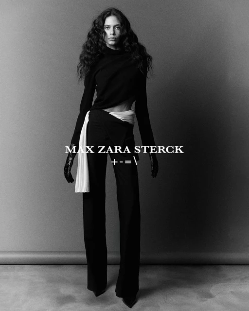Elegant fashion portrait of a woman in black clothing with long wavy hair, standing in front of a grey backdrop with overlaid text.