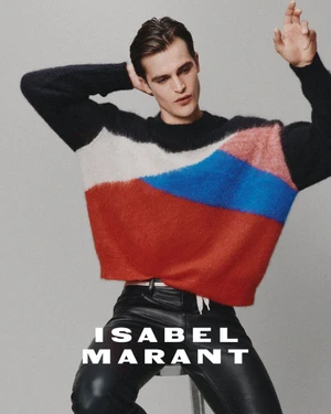 Man wearing a colorblocked sweater and black leather pants against a grey seamless background for Isabel Marant.