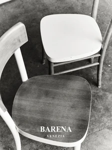 Two wooden chairs viewed from above in a monochrome setting with text overlay Barena Venezia