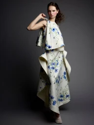 Model Giselle Norman wearing a white floral dress in a studio fashion editorial for 10 Magazine Japan photographed by Victor Demarchelier.