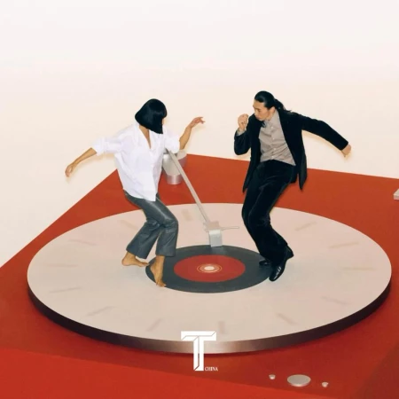 Two people in fashionable attire dance on an oversized red-and-white vinyl record, set against a stark white backdrop.