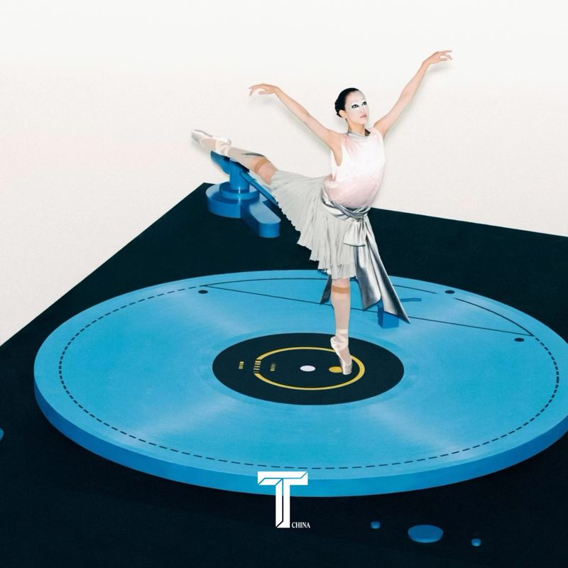 Graceful ballerina strikes pose on a vintage blue record player. Dressed in a light pink leotard and short, silver skirt, indoor setting.