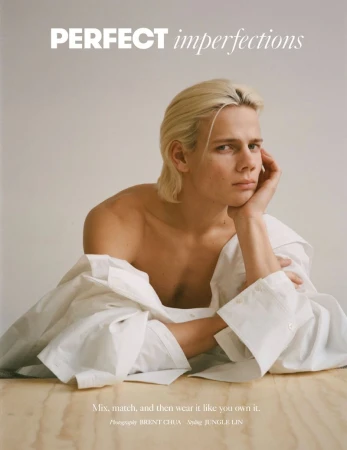 Portrait of a young adult with blond hair in a white collared shirt, resting their head on their hand, with text overlay.