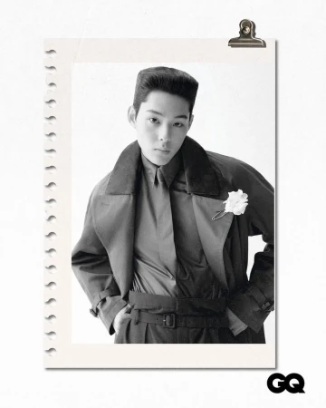 A black and white portrait of a young adult in a vintage-style coat and shirt, pinned to a notepad, with the GQ logo in the corner.
