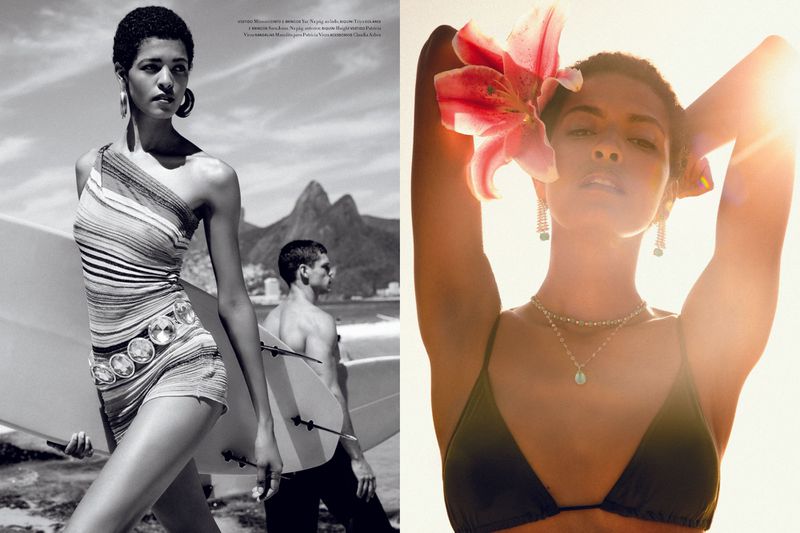 Black and white beach scene showcases a woman in a striped one-piece swimsuit with mountains and a surfer visible in the background.