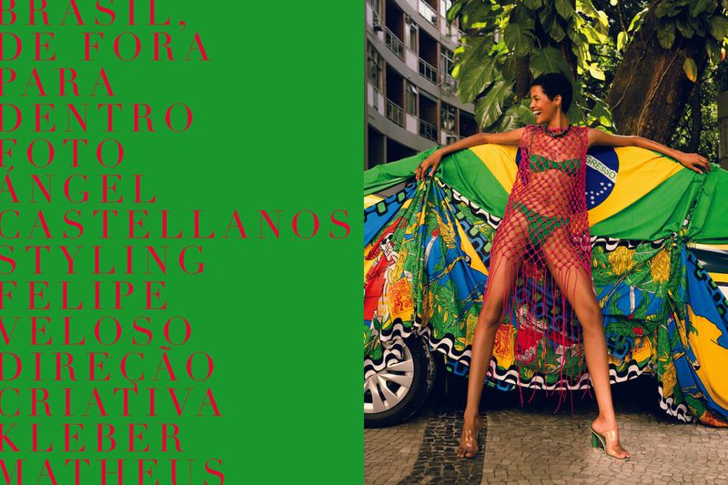 A fashion photo features a woman in a bikini and pink netting posing next to a car draped with the Brazilian flag in an outdoor setting.
