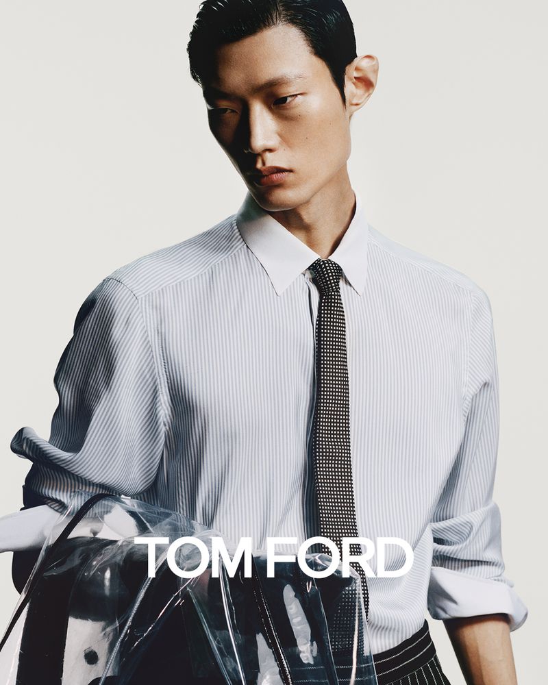 An Asian male model showcases a striped dress shirt and tie, with Tom Ford branding visible, against a neutral backdrop in a studio shot.