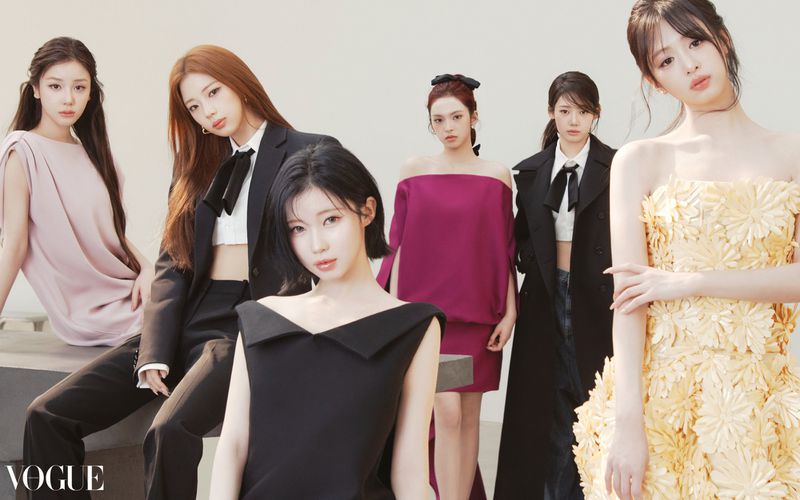 Group shot of six Asian women wearing formal dresses and business attire against a clean white backdrop, fashion editorial style.