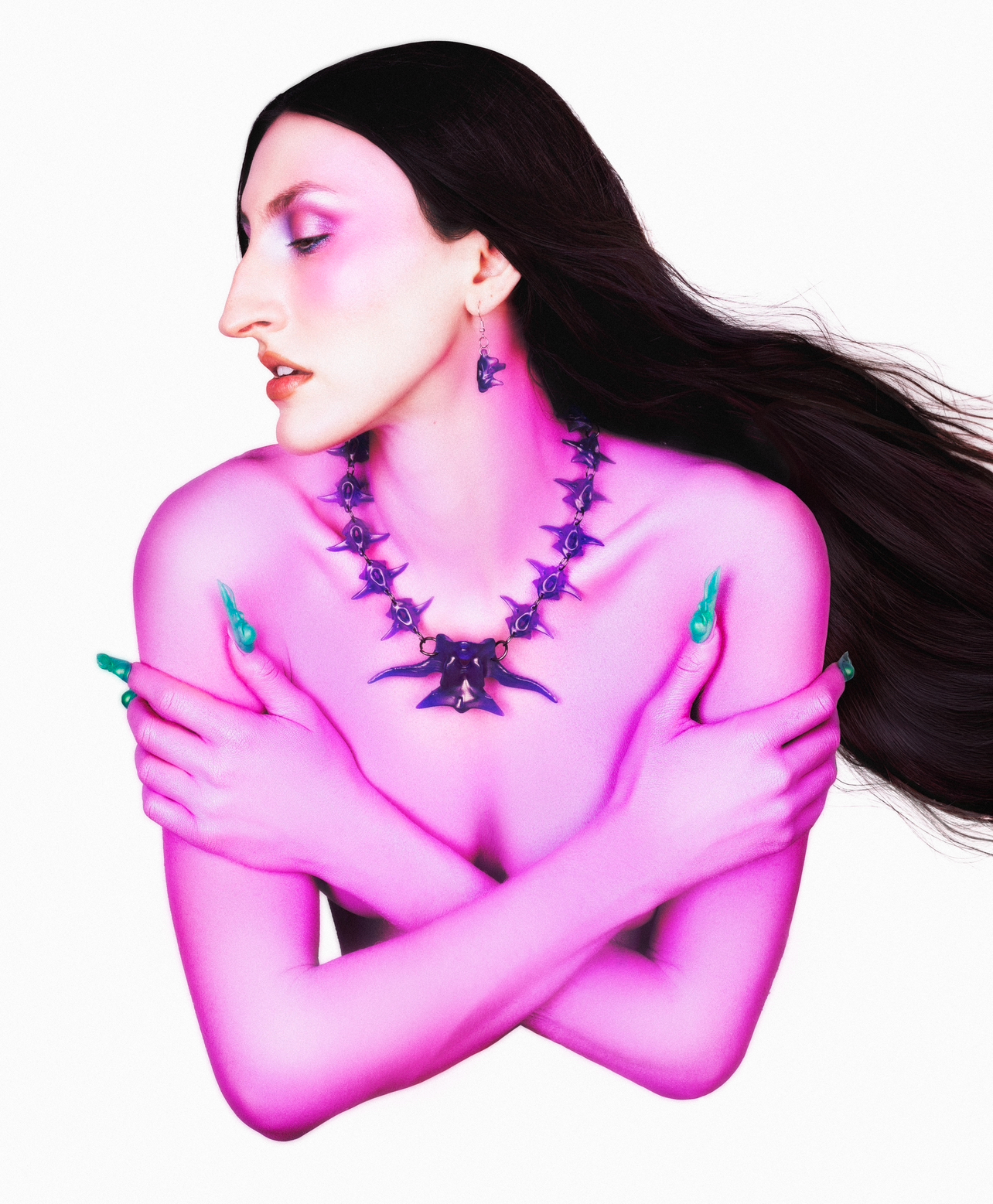Model Riley Woodell with dark hair wearing a purple statement necklace against a white background for the Alien Angel project.