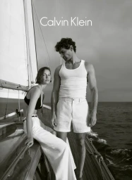Black and white portrait of a man and woman on a sailboat deck for Calvin Klein Menswear, photographed by Sonia Szóstak.