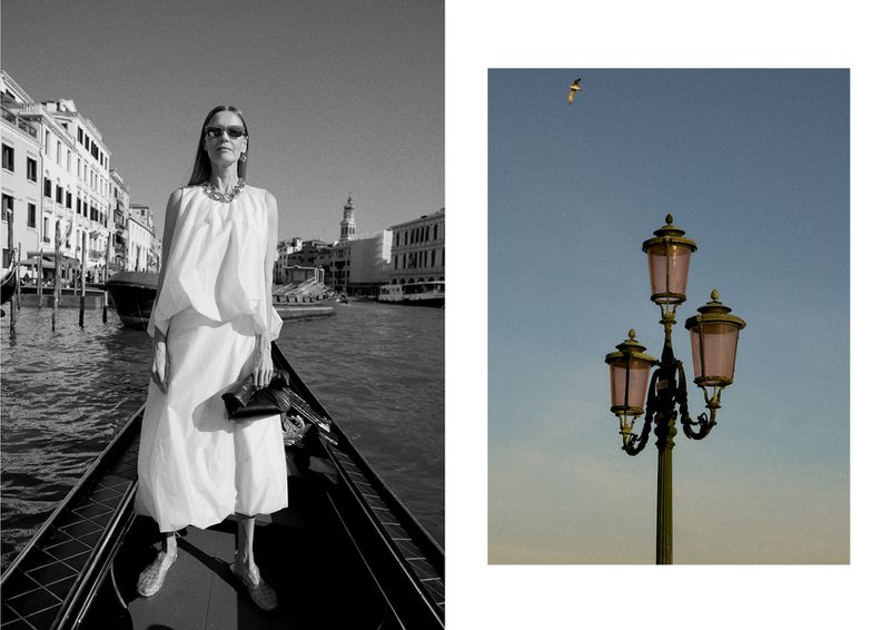 Black and white portrait of an adult female in a white dress and sunglasses on a gondola ride through the canals of Venice.