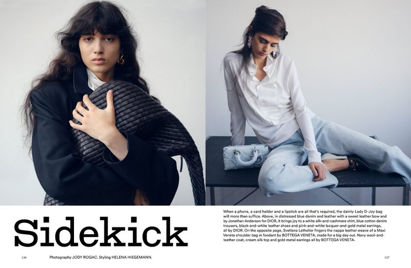 Two fashion models showcase apparel and accessories in an indoor editorial setting. One model poses with a quilted handbag and a dark blazer.