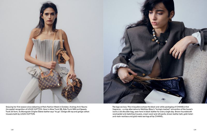 Two fashion models showcase Louis Vuitton handbags in a studio, wearing stylish clothing and accessories against a plain backdrop.