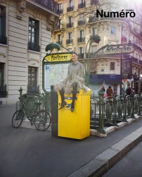 Dilan Cicek Deniz sitting on a yellow post box in Paris for Numero Istanbul editorial