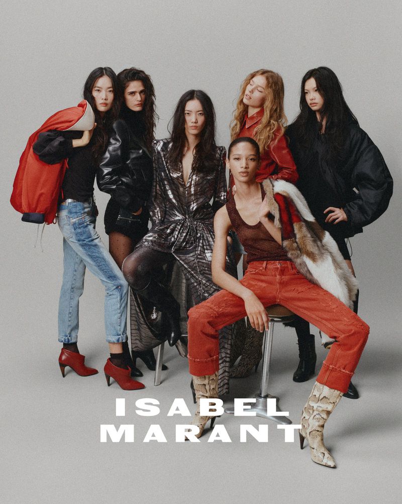 Group fashion shot of six female models wearing various clothing from Isabel Marant, including jackets, dresses, jeans, and boots in a studio.