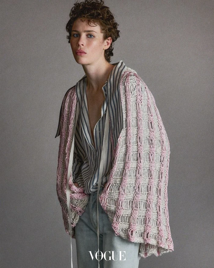 Model Jesi Evans wearing striped shirt and textured knit cardigan against a grey backdrop for Vogue Thailand