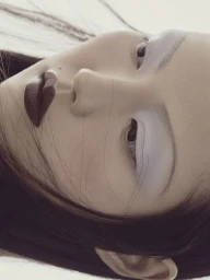 Close-up beauty portrait of a model with pale eyeshadow and dark burgundy lipstick against a neutral background.