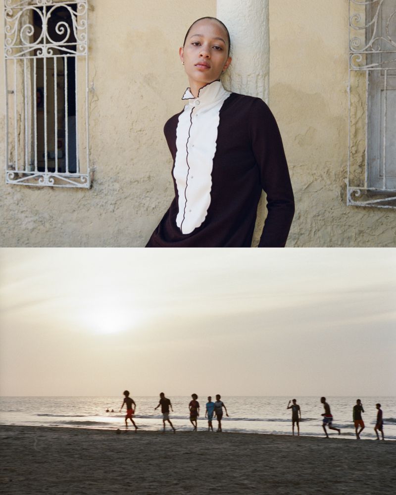 Fashion portrait of a slender model in a vintage-inspired brown dress with a white frilled collar and lower view of people playing soccer on a beach.