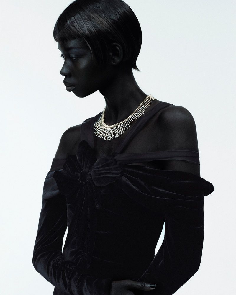 Model Nyanderi Deng wearing a diamond necklace and black velvet dress against white for L'Officiel Italia Star Diamonds