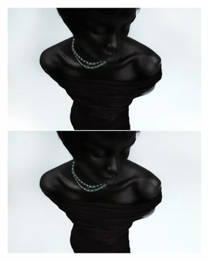 High-angle portrait of Nyanderi Deng wearing a diamond necklace and dark off-the-shoulder dress for L'Officiel Italia Star Diamonds.