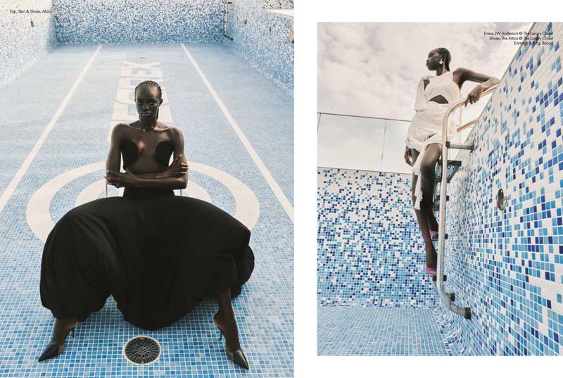 Fashion editorial shot of two black female fashion models posing in dresses inside an empty swimming pool with mosaic tile.