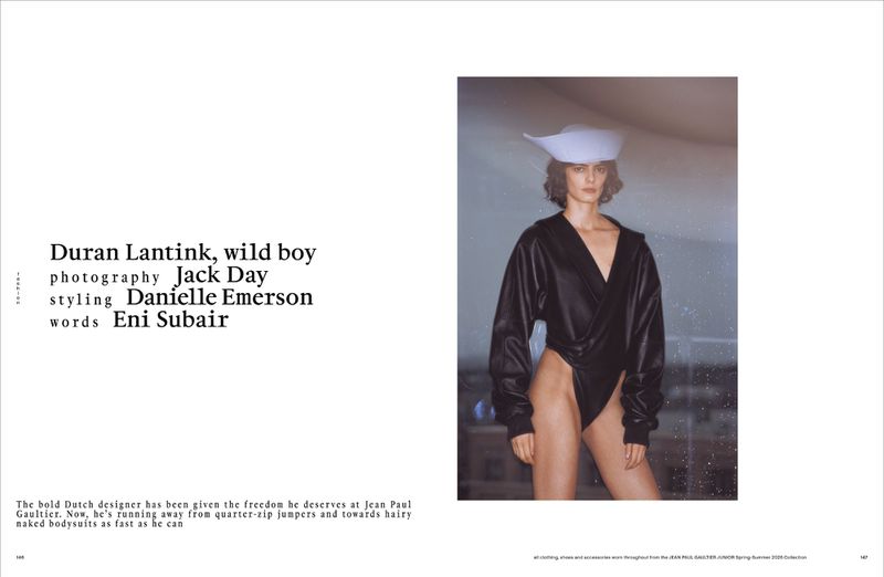 Fashion editorial image of a woman in a black bodysuit and white hat posing in front of a window, featuring creative direction and styling.