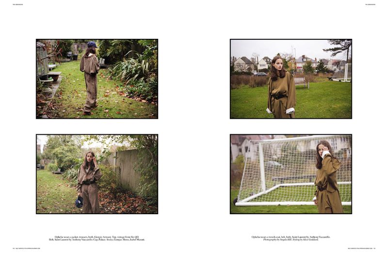Fashion editorial featuring a young woman in a brown jacket and pants, posing in an outdoor grassy setting with trees and houses.