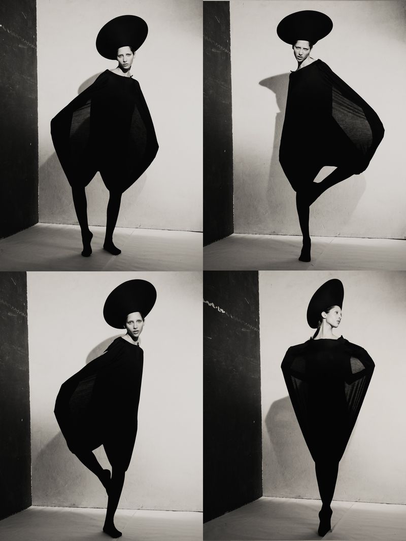 Model Yasmin Wijnaldum wearing a black sculptural garment and wide round hat against a white wall in four panel shots.