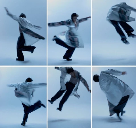 Montage of a person in motion wearing an open white coat, dark pants, and dark shoes against a solid light blue background.