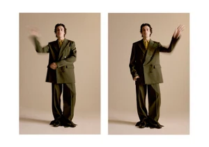 Two side-by-side frames of a man in an olive green suit and yellow shirt with motion blur on his arms against a plain neutral background
