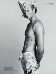 Monochrome portrait of actor Matthew Noszka wearing a folded newspaper hat and patterned trousers against a grey backdrop