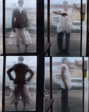 Four window panels show two people in different outfits and poses, creating an artistic and fashion-focused visual narrative.