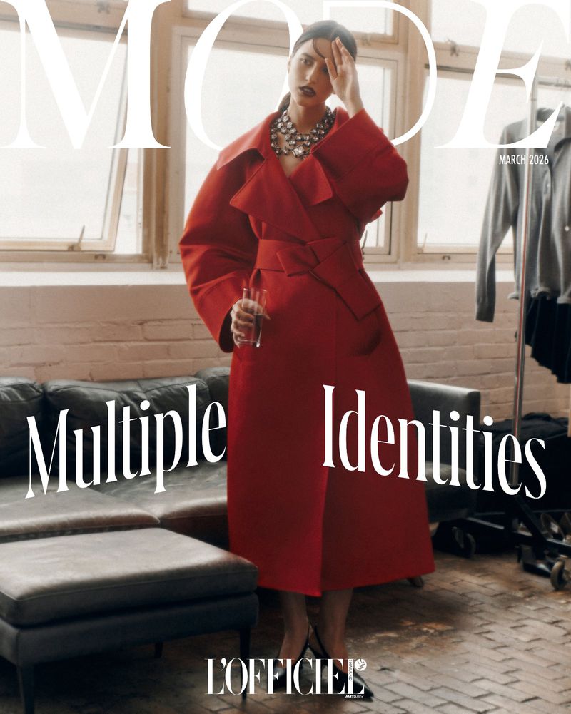 Magazine cover featuring a woman in a red coat, jewelry, and heels, holding a glass bottle, with the title "MODE" and "Multiple Identities."