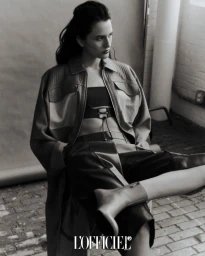 Model wearing a leather jacket and boots seated in an industrial interior for L'Officiel Thailand