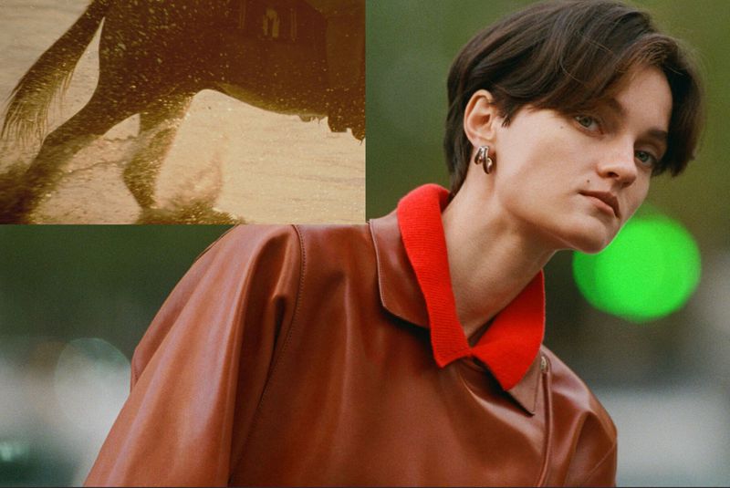 Model with short brown hair, wearing a leather jacket, stands outdoors against a green leafy background; an abstract golden image is shown in the upper left.