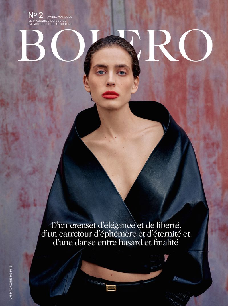 Bolero magazine cover featuring a model in a black top with a plunging neckline and red lipstick, against a textured background.