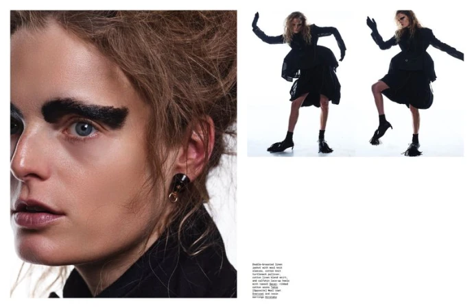 Avant-garde fashion shot showcasing a model with dramatic makeup and dark clothing, striking a pose against a bright white background.