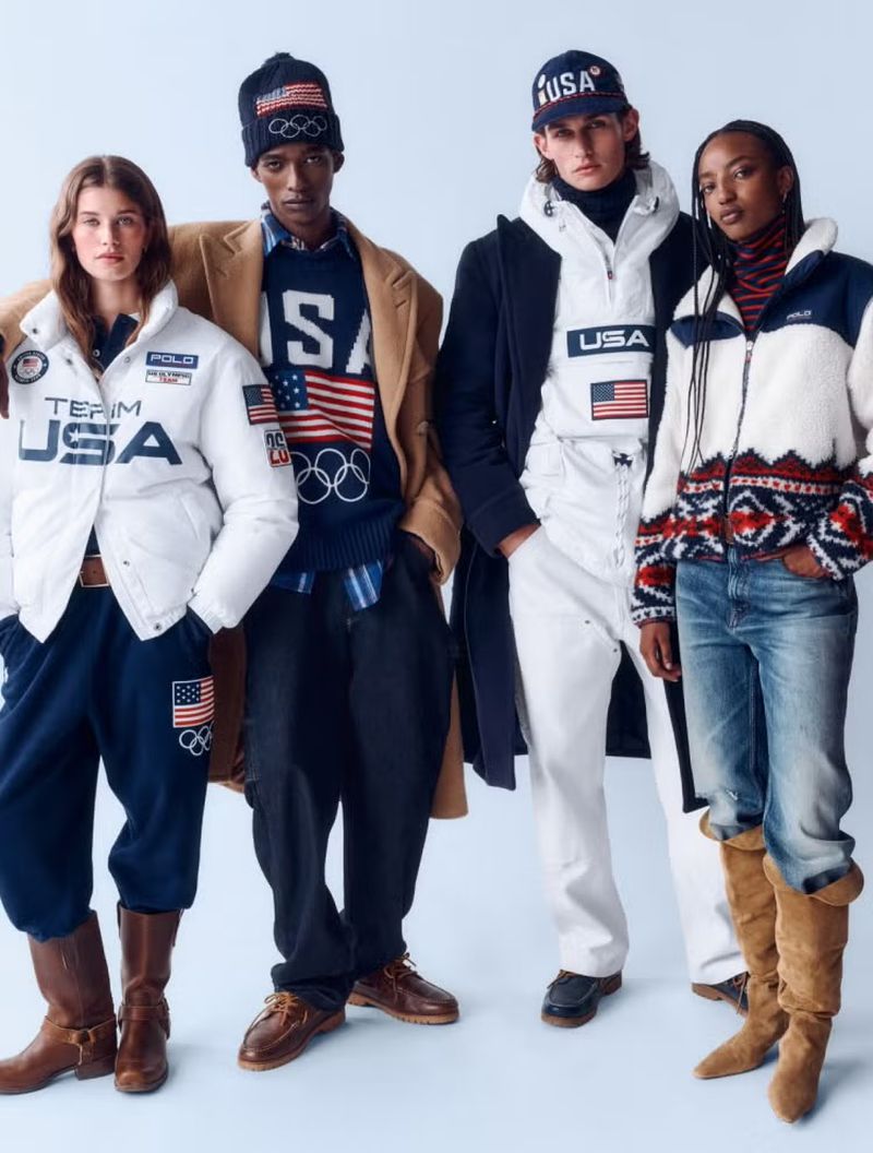 Group of four fashion models in Ralph Lauren Team USA Olympic apparel, posing indoors against a light background, promoting sportswear.