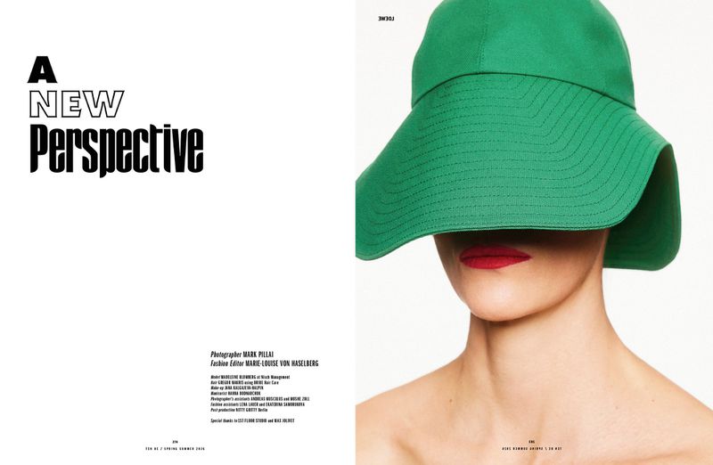 Fashion shot of a model wearing a wide-brimmed green hat and red lipstick against a bright background. Editorial makeup and design.