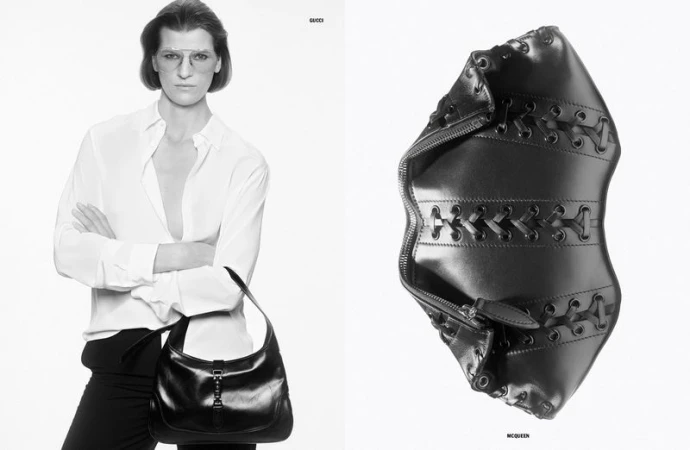 Monochrome fashion shot of a woman in a white shirt holding a black leather purse, next to a black leather accessory.