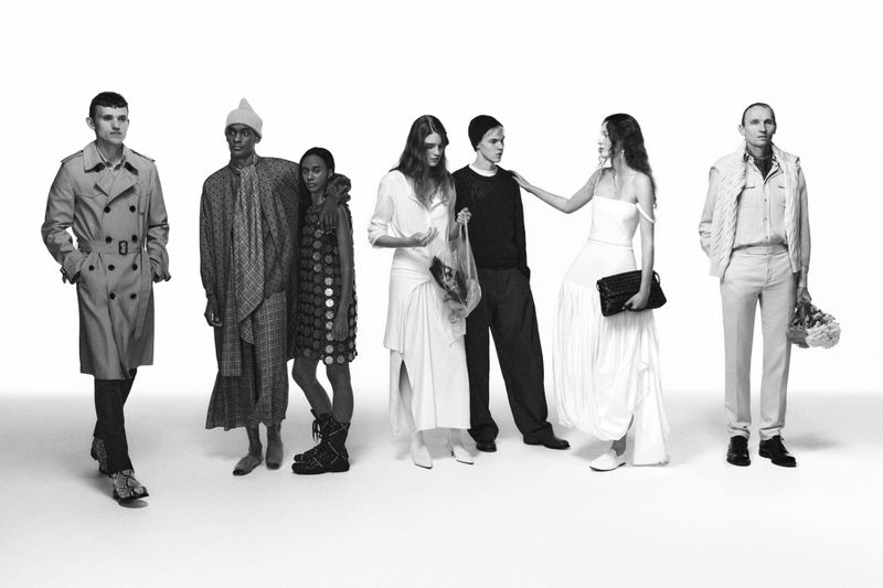 Diverse group of six fashion models wearing stylish apparel in a black-and-white studio shot, showcasing the latest trends in modern clothing.