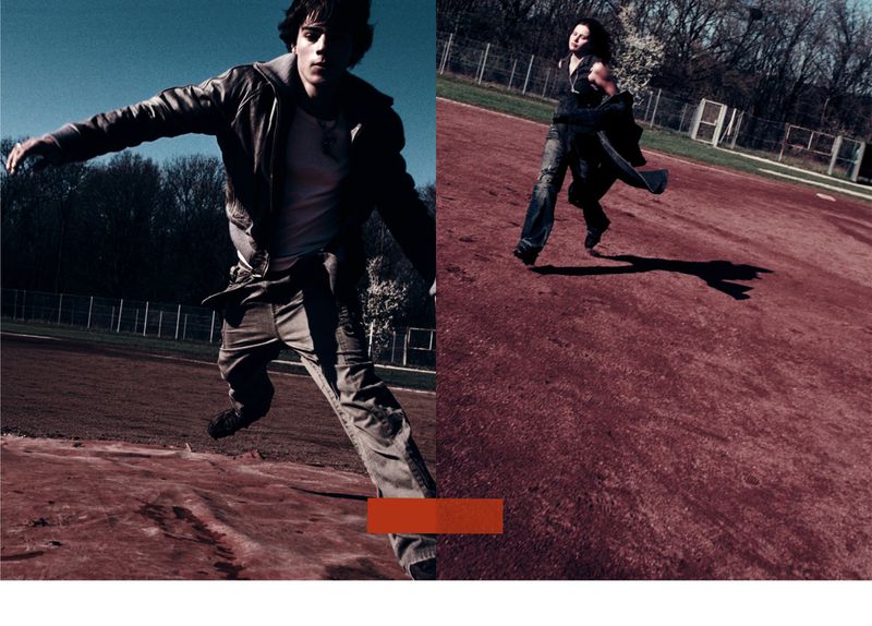 Two people posing outdoors: one mid-jump wearing a leather jacket and jeans, another running in jeans and jacket against a background of trees.