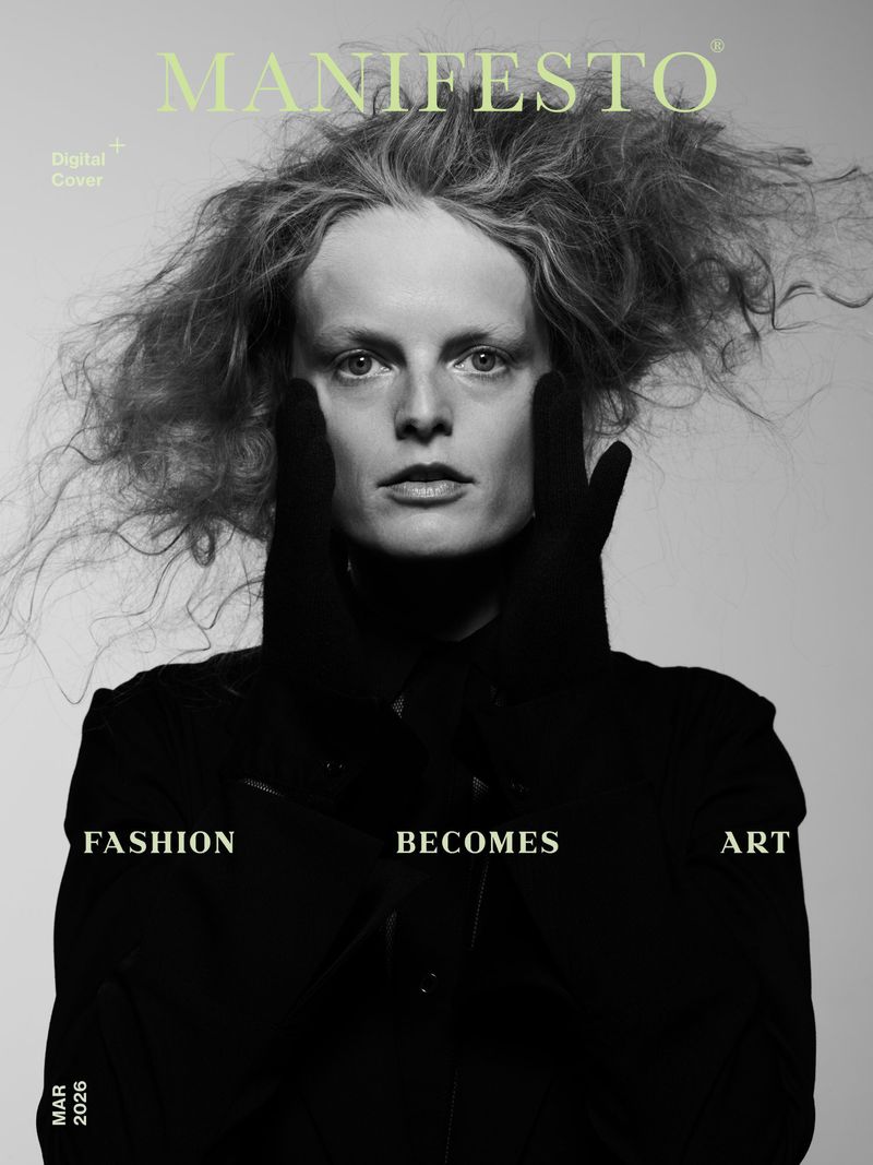 Fashion magazine cover features a model with frizzy hair wearing black jacket and gloves against a neutral background with title text.