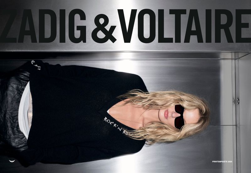 Fashion ad featuring a blonde woman with sunglasses and a black sweater lying against a metal surface, promoting Zadig & Voltaire.