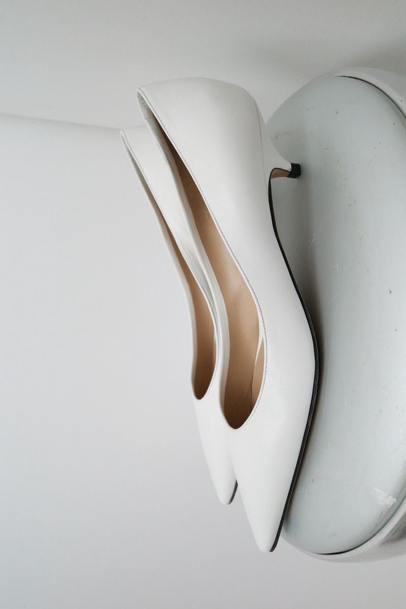 Elegant white heeled shoes on a white surface, perfect for fashion and beauty-related content. Minimalist aesthetic.