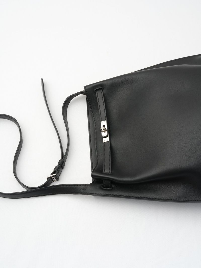 Studio shot of a black leather shoulder bag with silver hardware against a white background, showcasing fashion accessory.