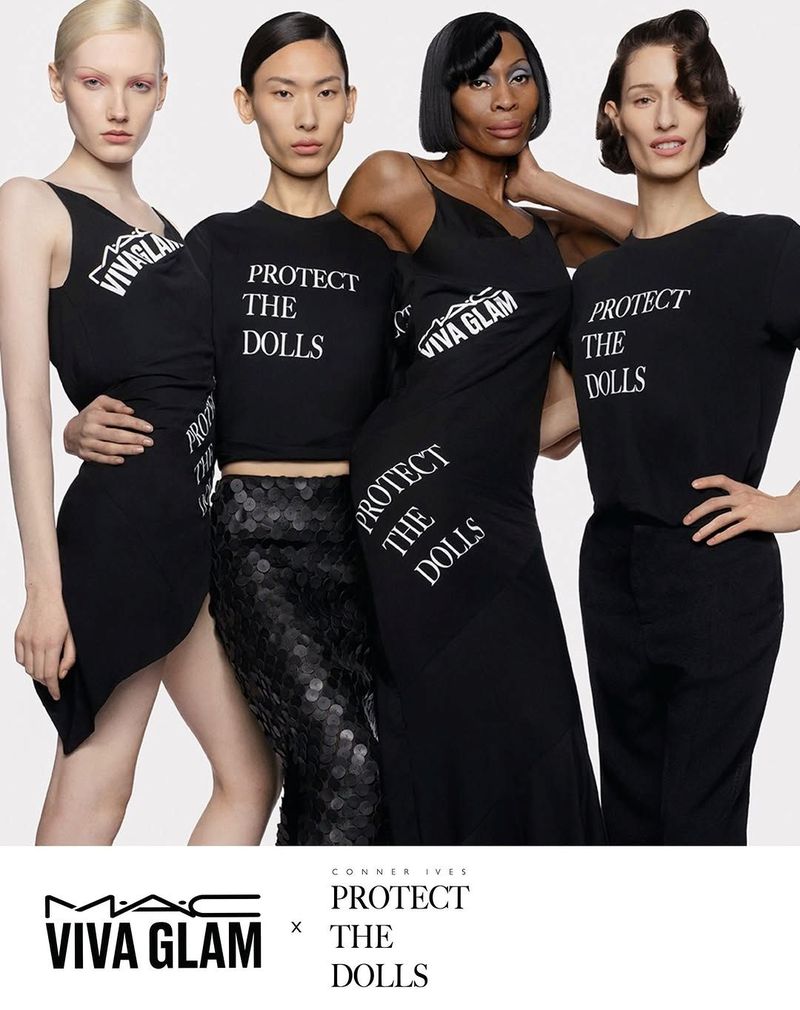 Four diverse women in black dresses and t-shirts pose for a fashion advertisement with MAC Viva Glam and Protect The Dolls branding.