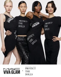 Four diverse models posing in matching black apparel with printed text against a clean white seamless studio background.