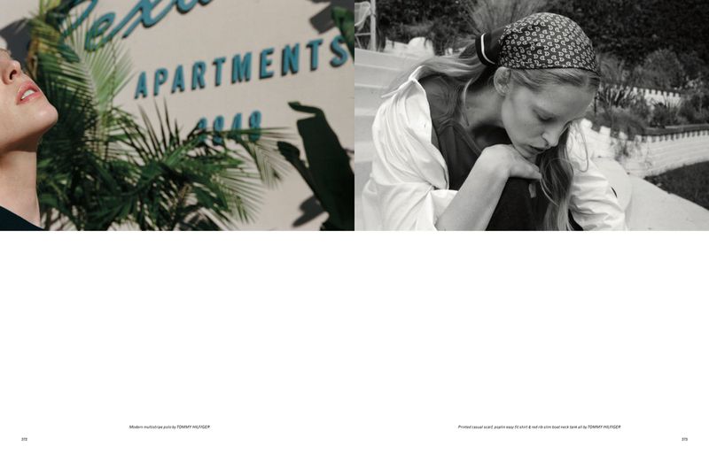 Monochrome editorial fashion shot: woman in headscarf with neutral expression, outdoor setting, contrasting architecture and greenery.